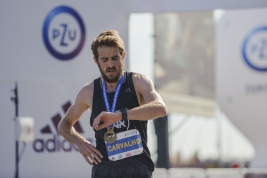 Florian-Carvalho-checking-the-time-after-crossing-the-finish-line-of-40th-PZU-Warsaw-Marathon-201809